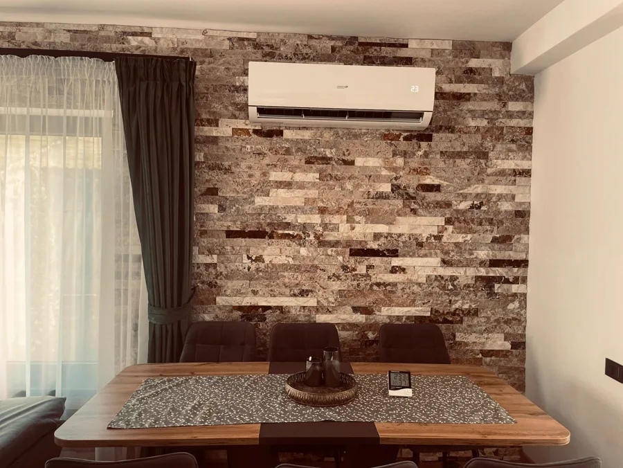 Dining room with stone wall and air conditioning